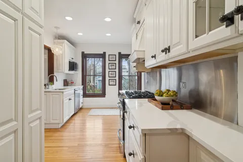 a kitchen with a sink a stove and cabinets