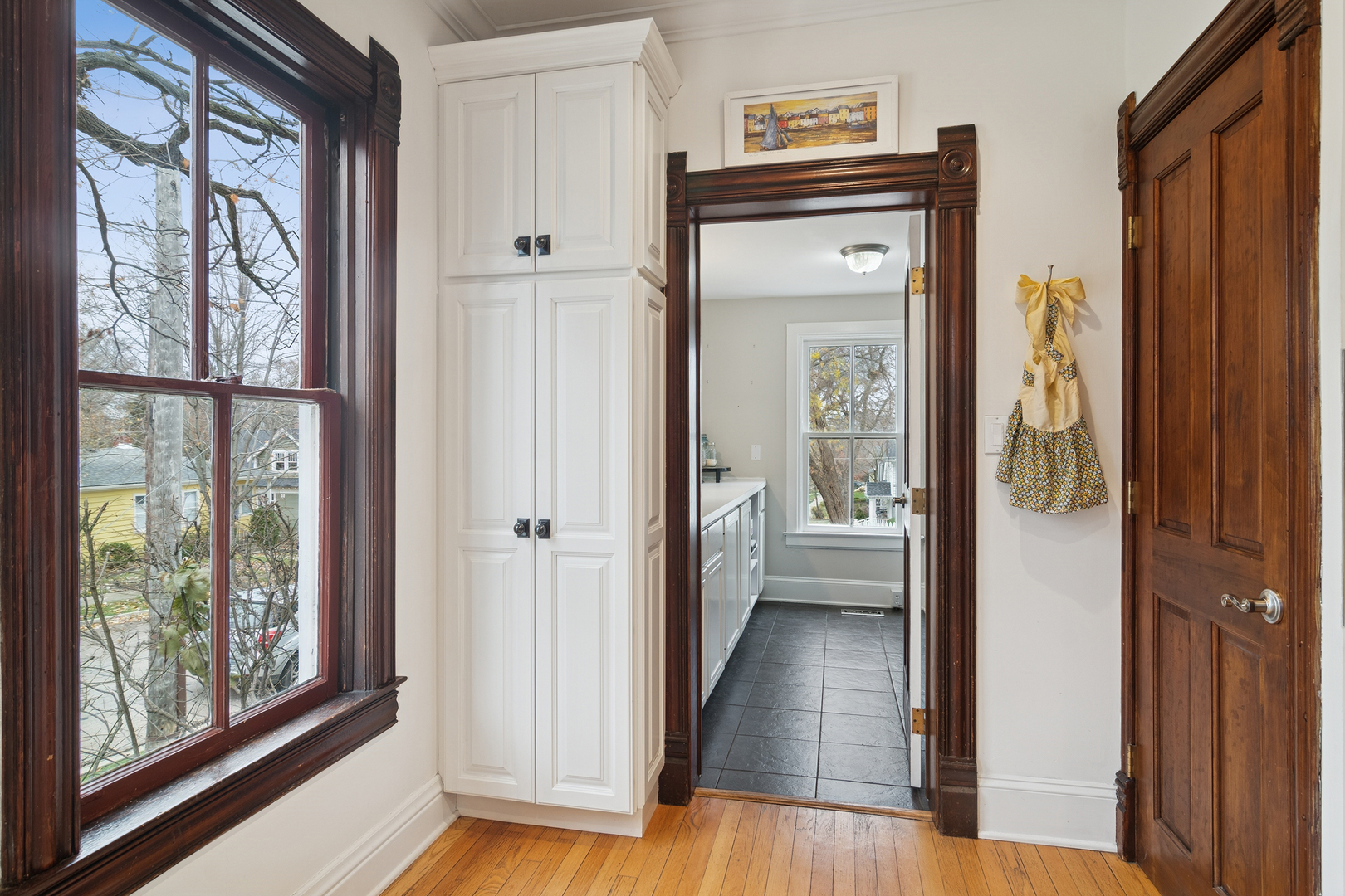 202 East Hillside Road Barrington, IL 60010 - Photo 14 of 37 a view of a hallway with wooden floor and windows with an outdoor view