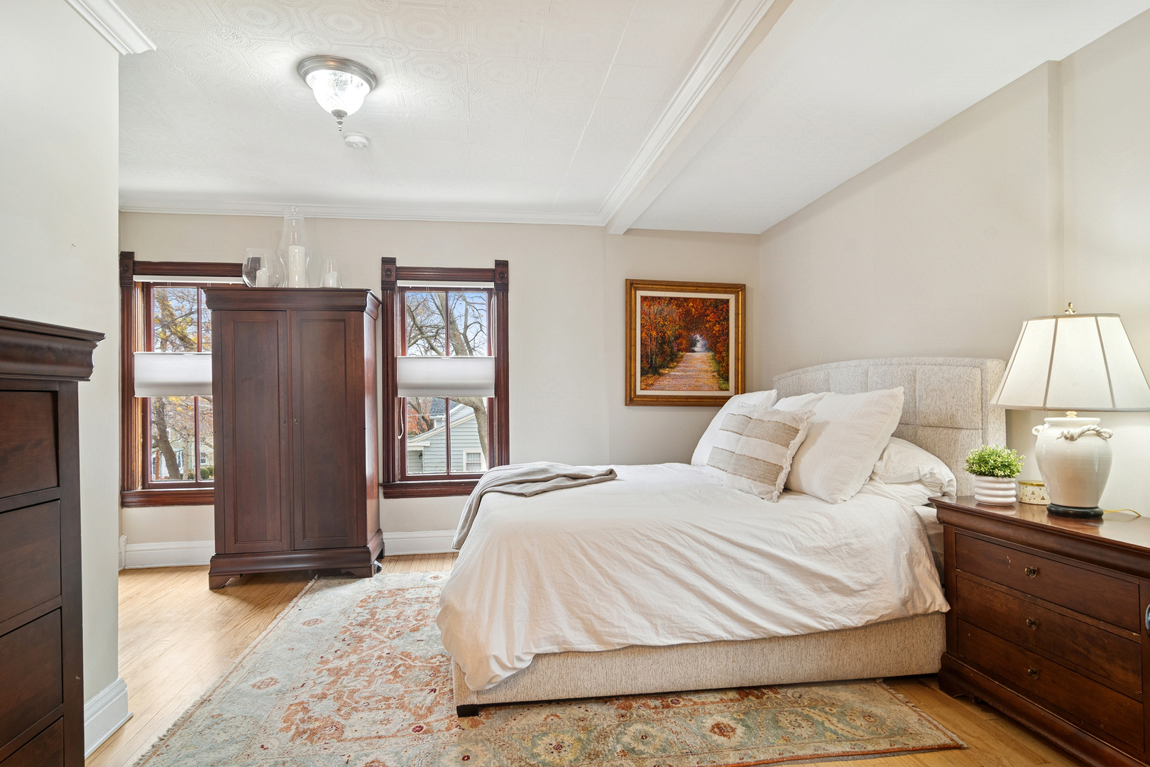 202 East Hillside Road Barrington, IL 60010 - Photo 18 of 37 a bedroom with a bed painting on wall and two windows