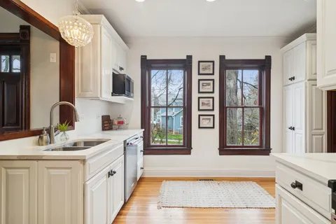 a bathroom with a granite countertop sink mirror and bathtub