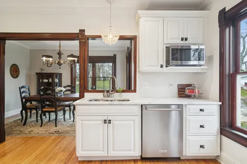 a kitchen with cabinets and chairs