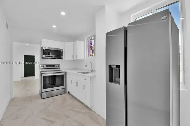 a kitchen with a refrigerator stove and microwave