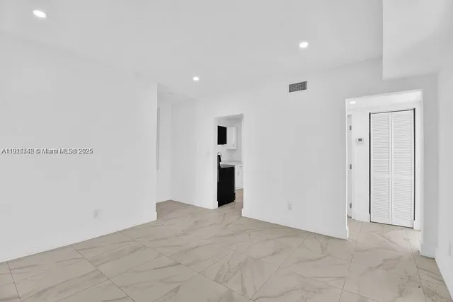 a view of a livingroom with wooden floor and entryway