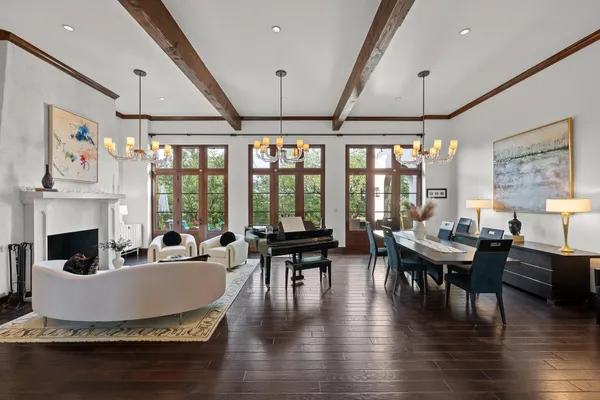 a living room with fireplace furniture and a large window