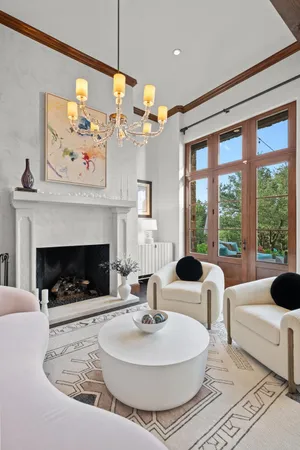 a living room with furniture a fireplace and a large window