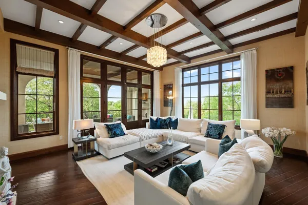 a living room with furniture and large windows