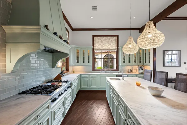 a kitchen with stove a sink and refrigerator