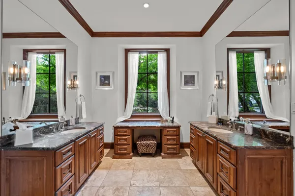 a spacious bathroom with a granite countertop sink and a mirror