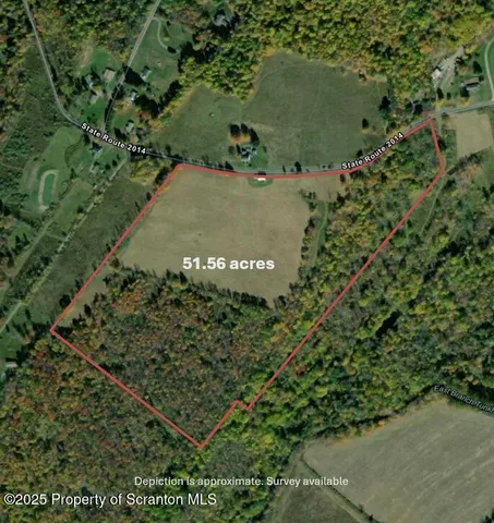 an aerial view of a residential houses with outdoor space