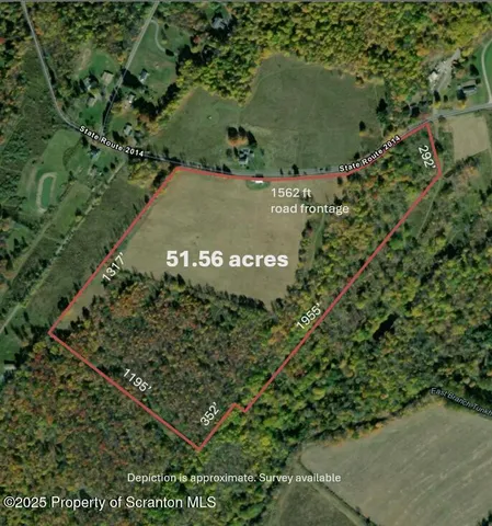 an aerial view of a residential houses with outdoor space