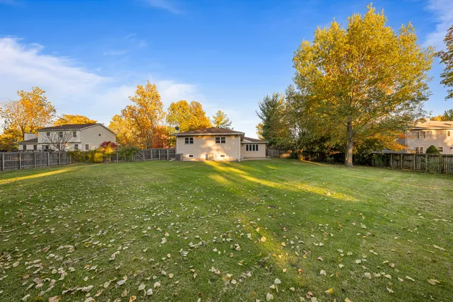a view of yard with swimming pool and green space