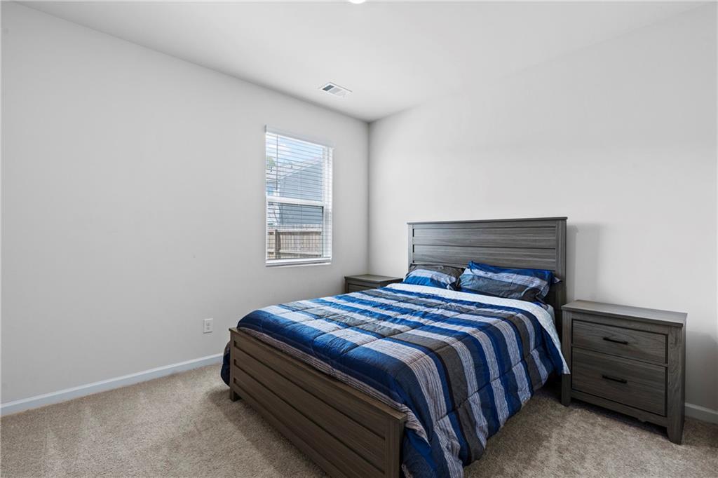 5367 Pennington Court Atlanta, GA 30349 - Photo 13 of 33 a bedroom with a bed and a window