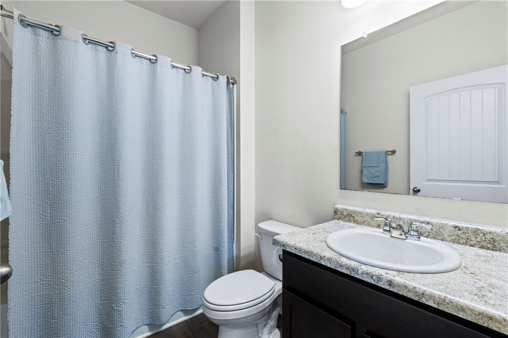 5367 Pennington Court Atlanta, GA 30349 - Photo 14 of 33 a bathroom with a granite countertop sink toilet and a mirror