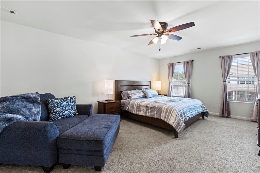 5367 Pennington Court Atlanta, GA 30349 - Photo 16 of 33 a bedroom with a bed couch and window