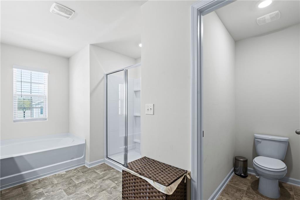 5367 Pennington Court Atlanta, GA 30349 - Photo 17 of 33 a bathroom with a toilet and a shower