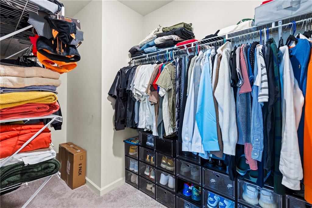 5367 Pennington Court Atlanta, GA 30349 - Photo 21 of 33 a view of walk in closet with clothes and shoes