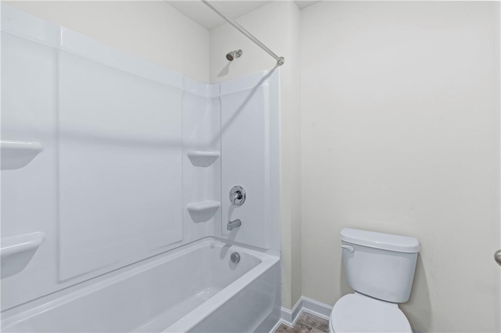 5367 Pennington Court Atlanta, GA 30349 - Photo 24 of 33 a bathroom with a toilet and a bathtub