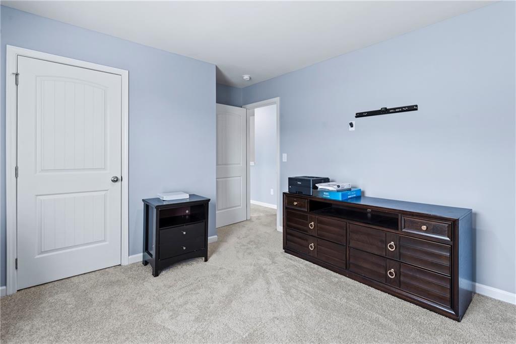 5367 Pennington Court Atlanta, GA 30349 - Photo 29 of 33 a room with furniture and a dresser