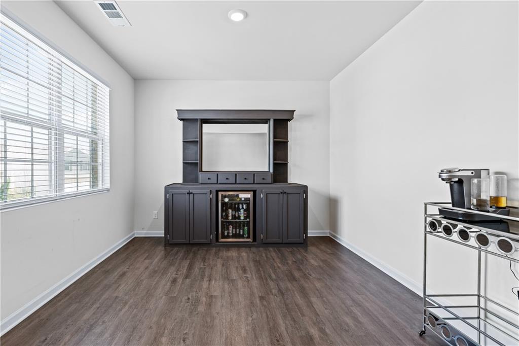 5367 Pennington Court Atlanta, GA 30349 - Photo 4 of 33 a living room with a couch and a wooden floor