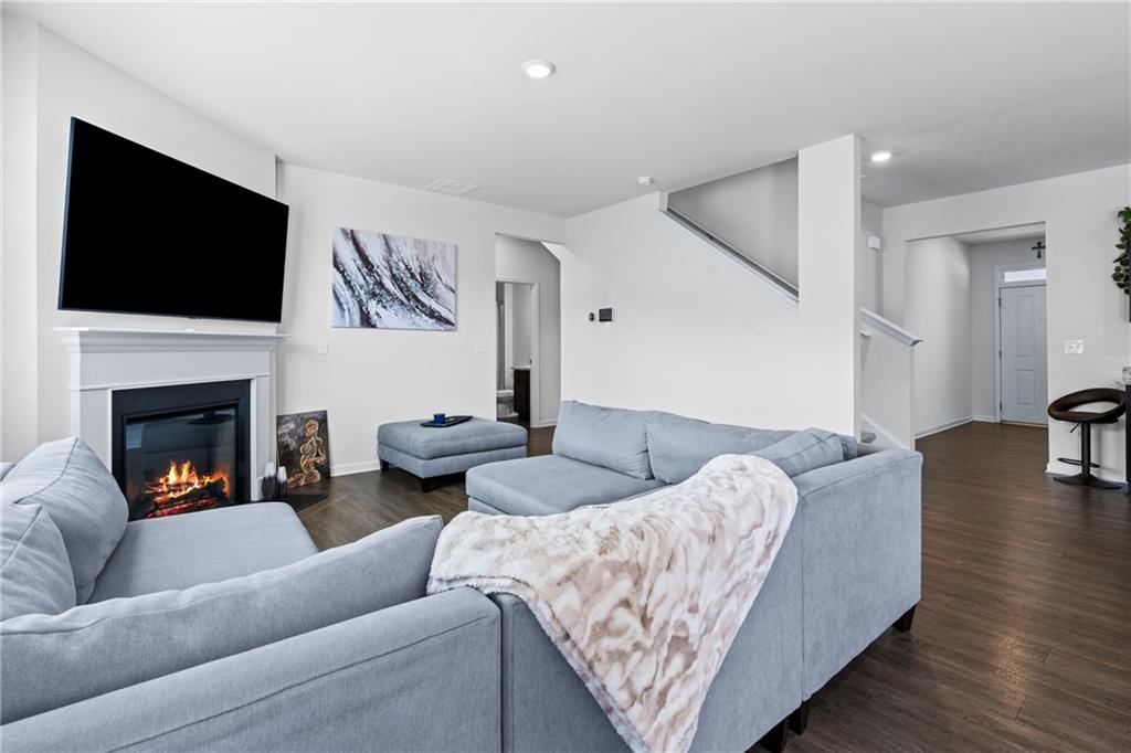 5367 Pennington Court Atlanta, GA 30349 - Photo 6 of 33 a living room with furniture fireplace and flat screen tv