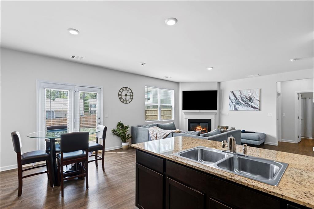 5367 Pennington Court Atlanta, GA 30349 - Photo 9 of 33 a kitchen with a table chairs sink and wooden floor