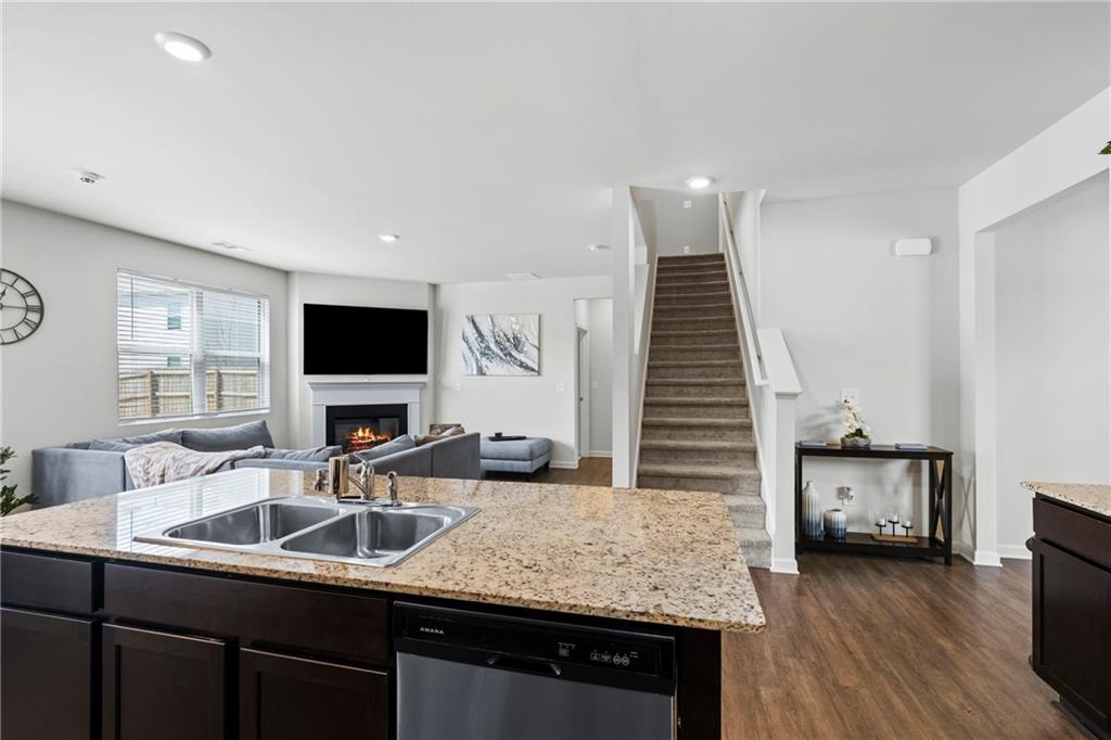 5367 Pennington Court Atlanta, GA 30349 - Photo 10 of 33 a kitchen with granite countertop a sink and a stove top oven