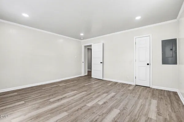 a view of an empty room with wooden floor