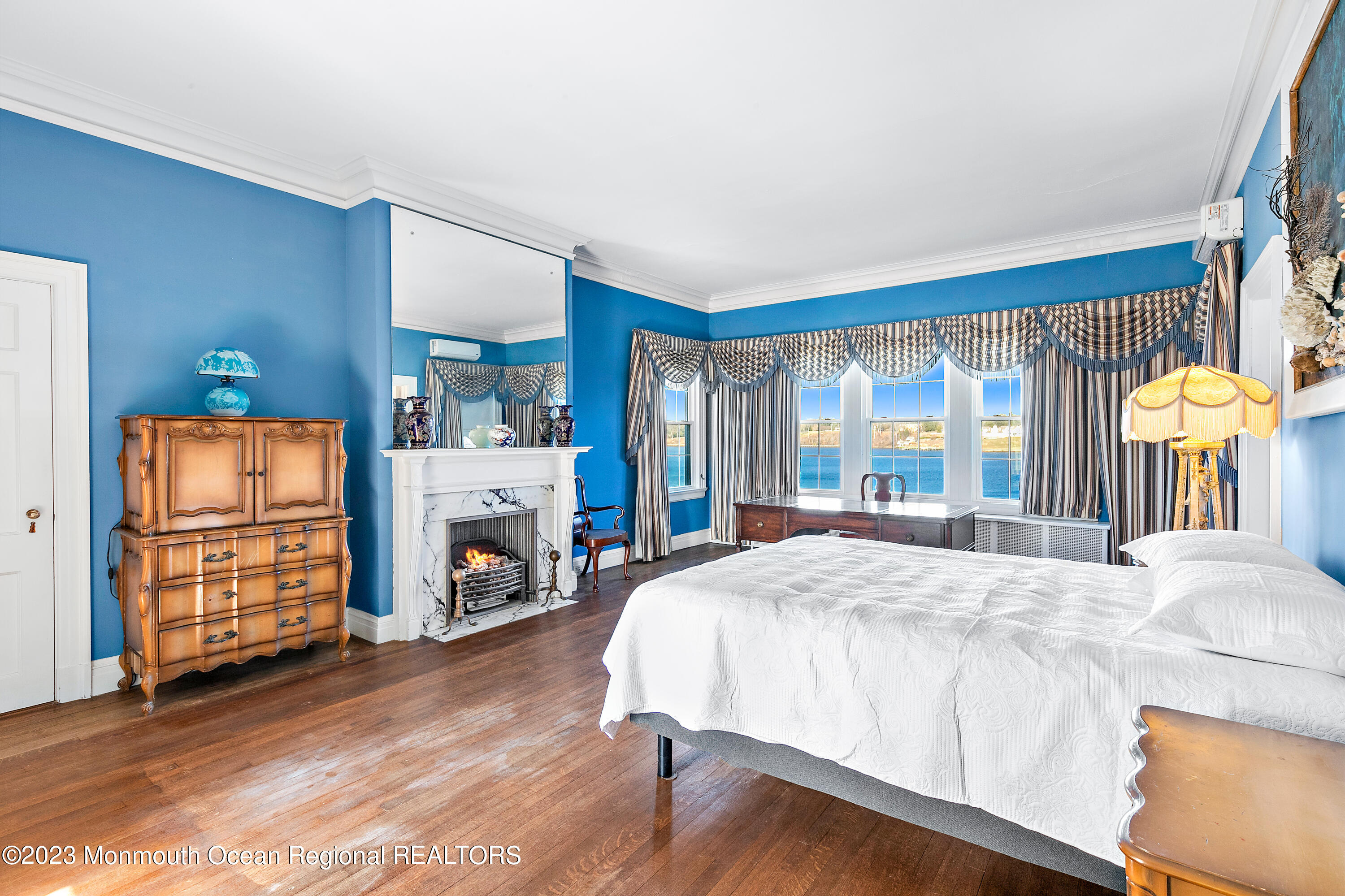 29 Hance Road Fair Haven, NJ 07704 - Photo 53 of 53 a bedroom with a bed a fireplace and a large window