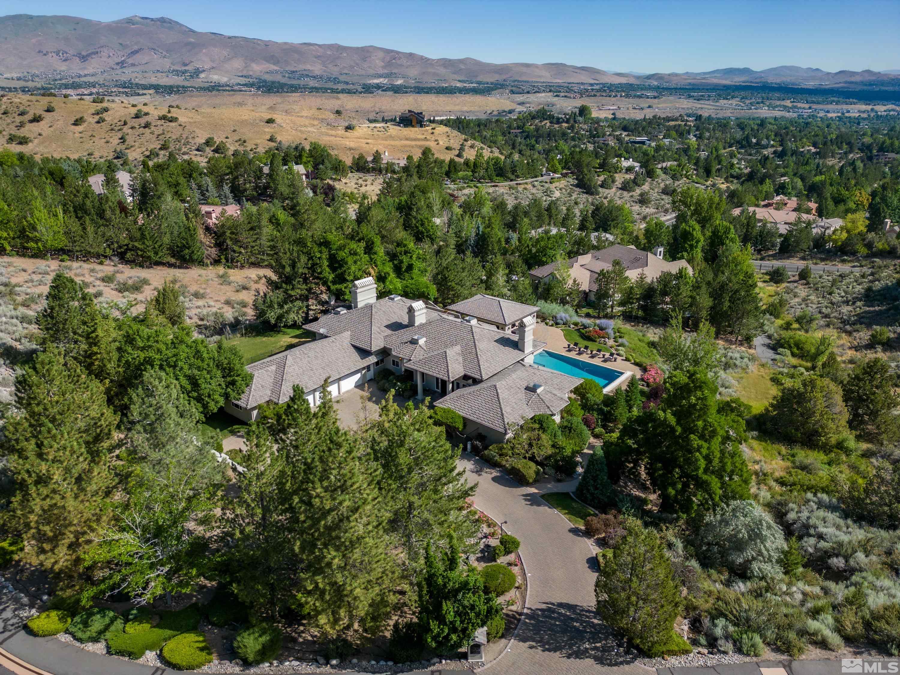 85 Hawken Road Reno, NV 89519 - Photo 36 of 40 an aerial view of a city with lots of residential buildings and mountain view in back