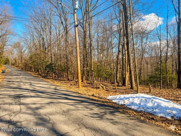 a view of house with snow on the road