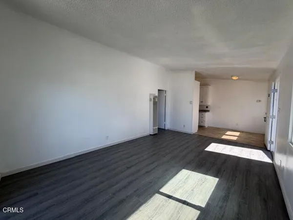 a view of an empty room and wooden floor