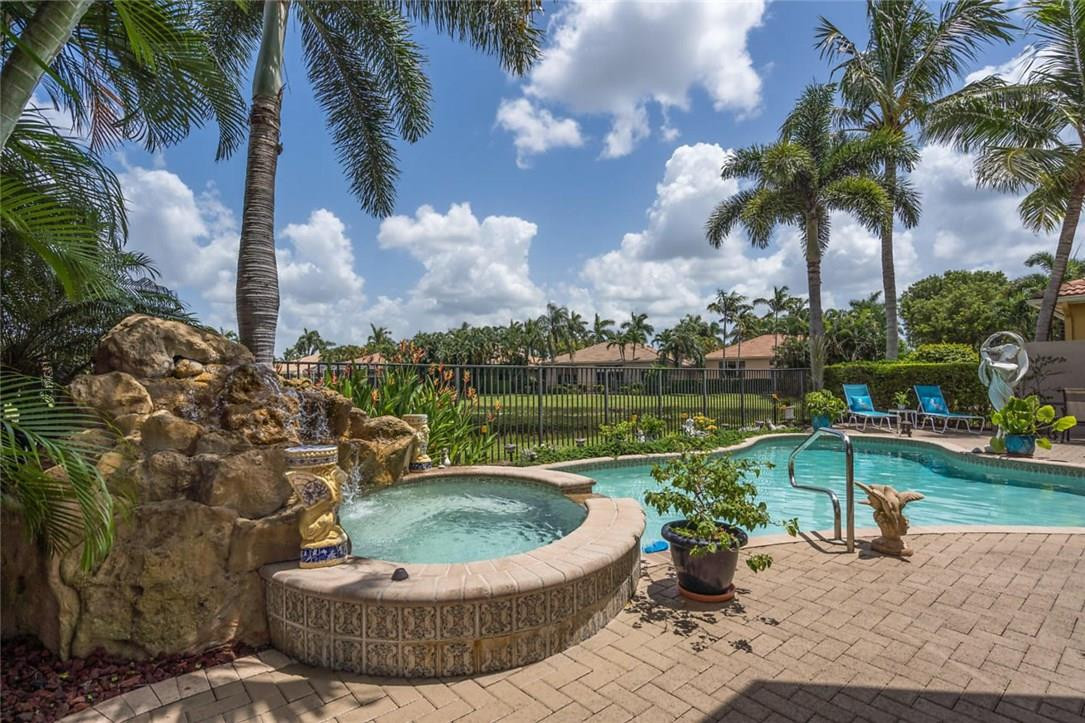 16391 Braeburn Ridge Trail Delray Beach, FL 33446 - Photo 25 of 31 Rock waterfall, spa and pool