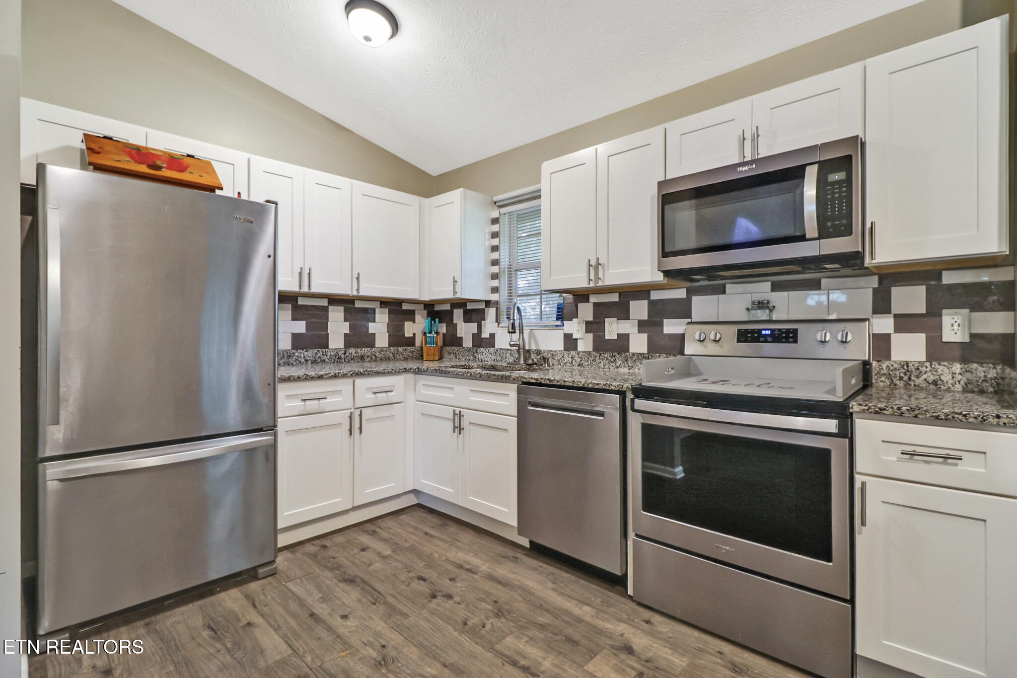 604 Bear Cub Lane Clinton, TN 37716 - Photo 6 of 23 a kitchen with white cabinets stainless steel appliances and a sink
