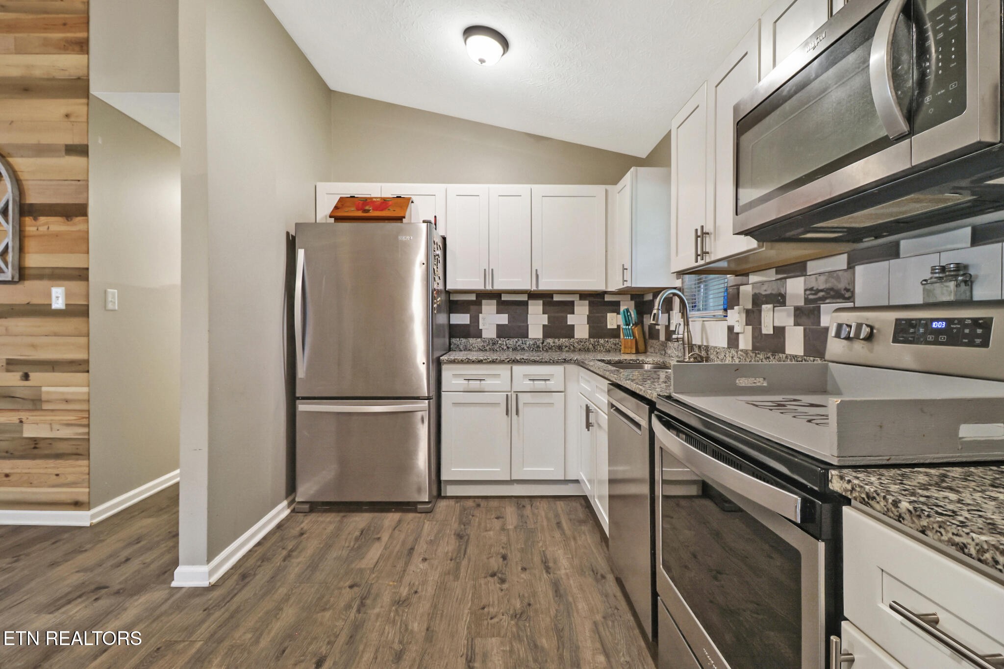 604 Bear Cub Lane Clinton, TN 37716 - Photo 7 of 23 a kitchen with stainless steel appliances granite countertop a refrigerator a stove and a sink