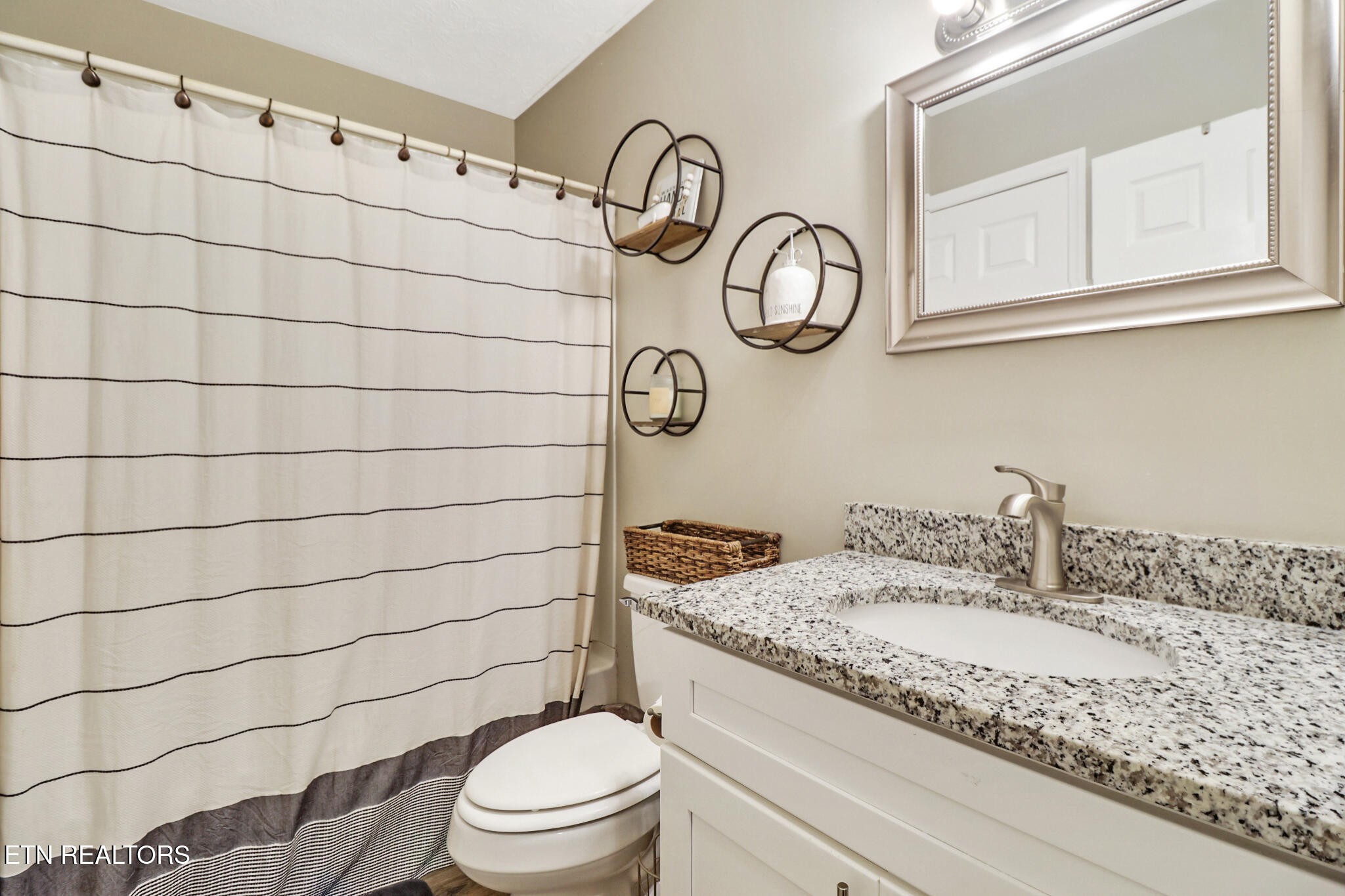 604 Bear Cub Lane Clinton, TN 37716 - Photo 10 of 23 a bathroom with a granite countertop toilet sink and mirror
