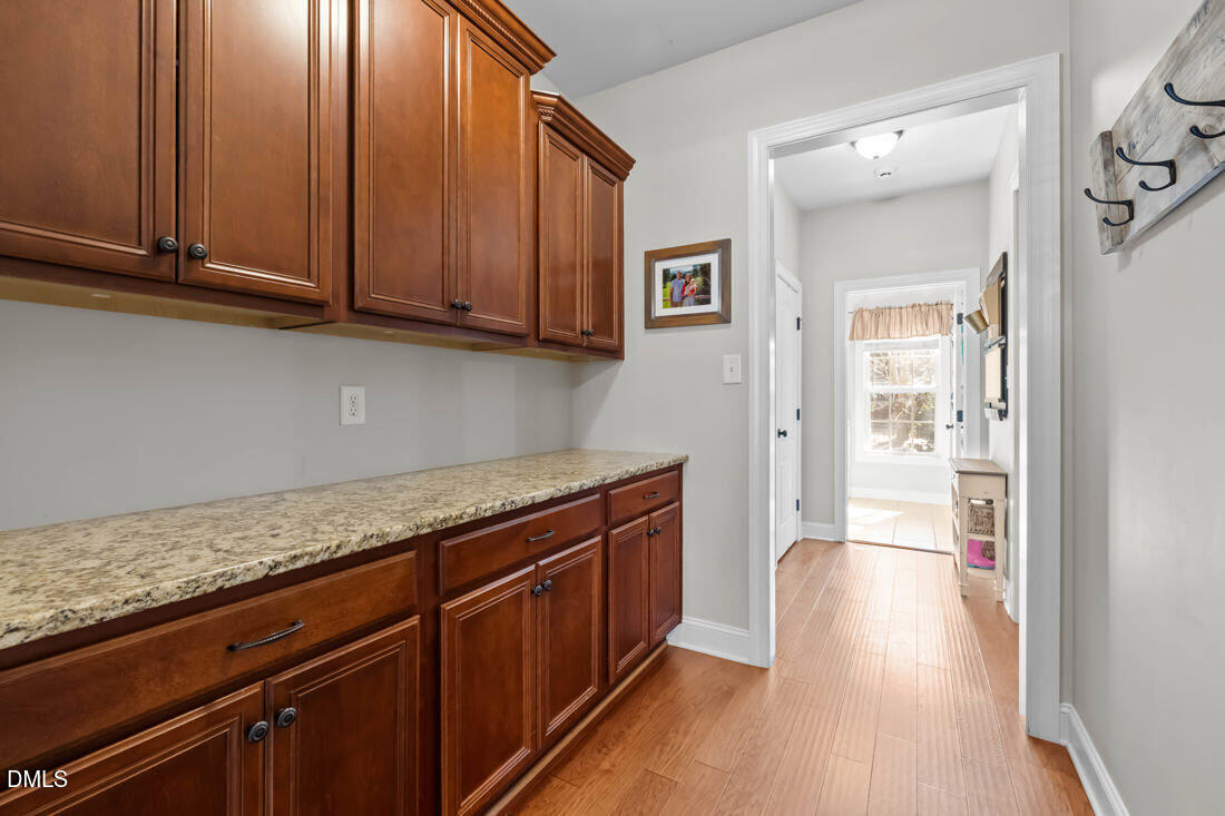 170 Valley Pines Circle Spring Lake, NC 28390 - Photo 9 of 55 a hallway with granite countertop wooden cabinets a sink and dishwasher