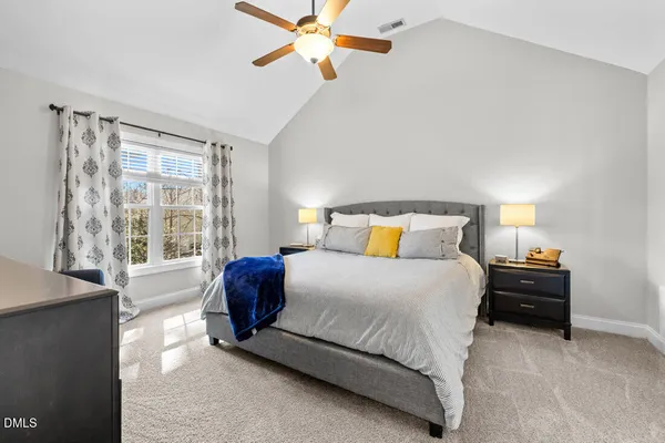 a view of a bedroom with furniture and windows