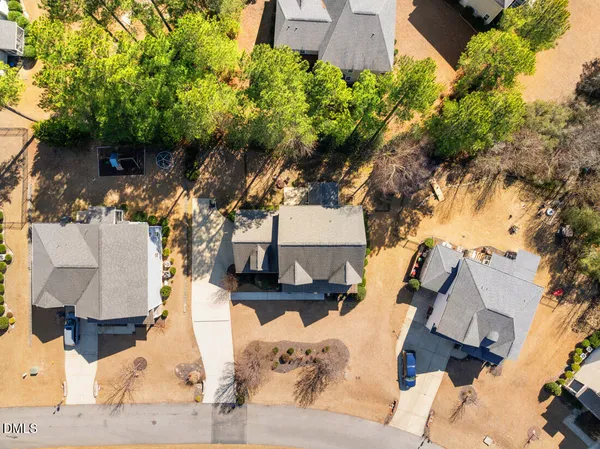 an aerial view of a house with a yard and lake view