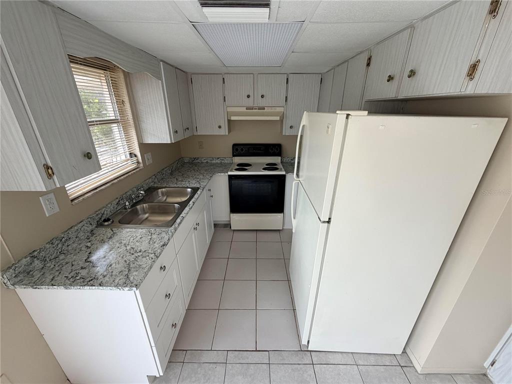 6330 Pennsylvania Avenue New Port Richey, FL 34653 - Photo 7 of 17 a kitchen with a refrigerator sink and stove