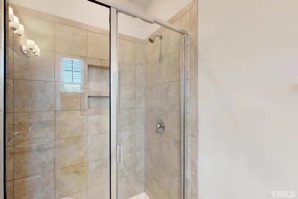 a bathroom with a granite countertop sink toilet a mirror and shower