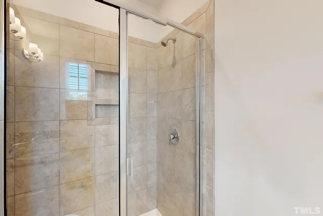 a bathroom with a granite countertop sink toilet a mirror and shower