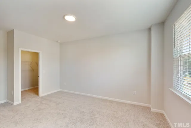 an empty room with a empty space and windows