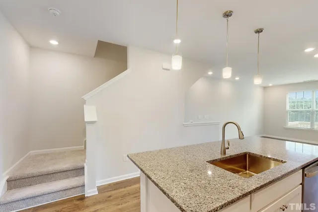 a view of a big room with wooden floor and windows