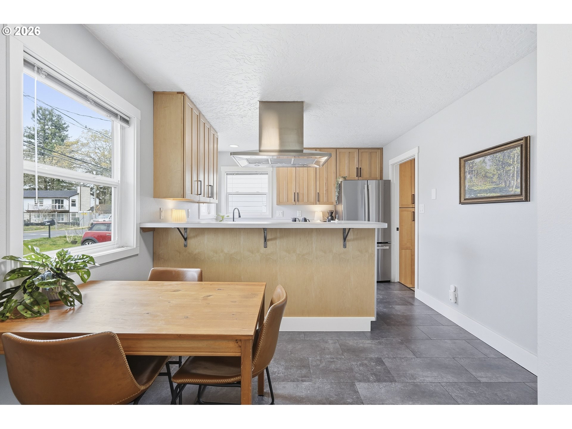 11250 Southwest 78th Avenue Tigard, OR 97223 - Photo 10 of 30 a kitchen with kitchen island a table and chair in it