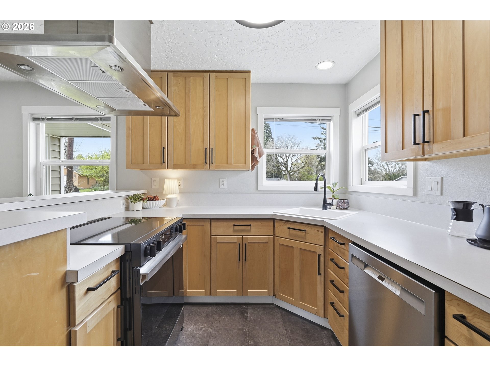 11250 Southwest 78th Avenue Tigard, OR 97223 - Photo 14 of 30 a kitchen with a sink stove and cabinets