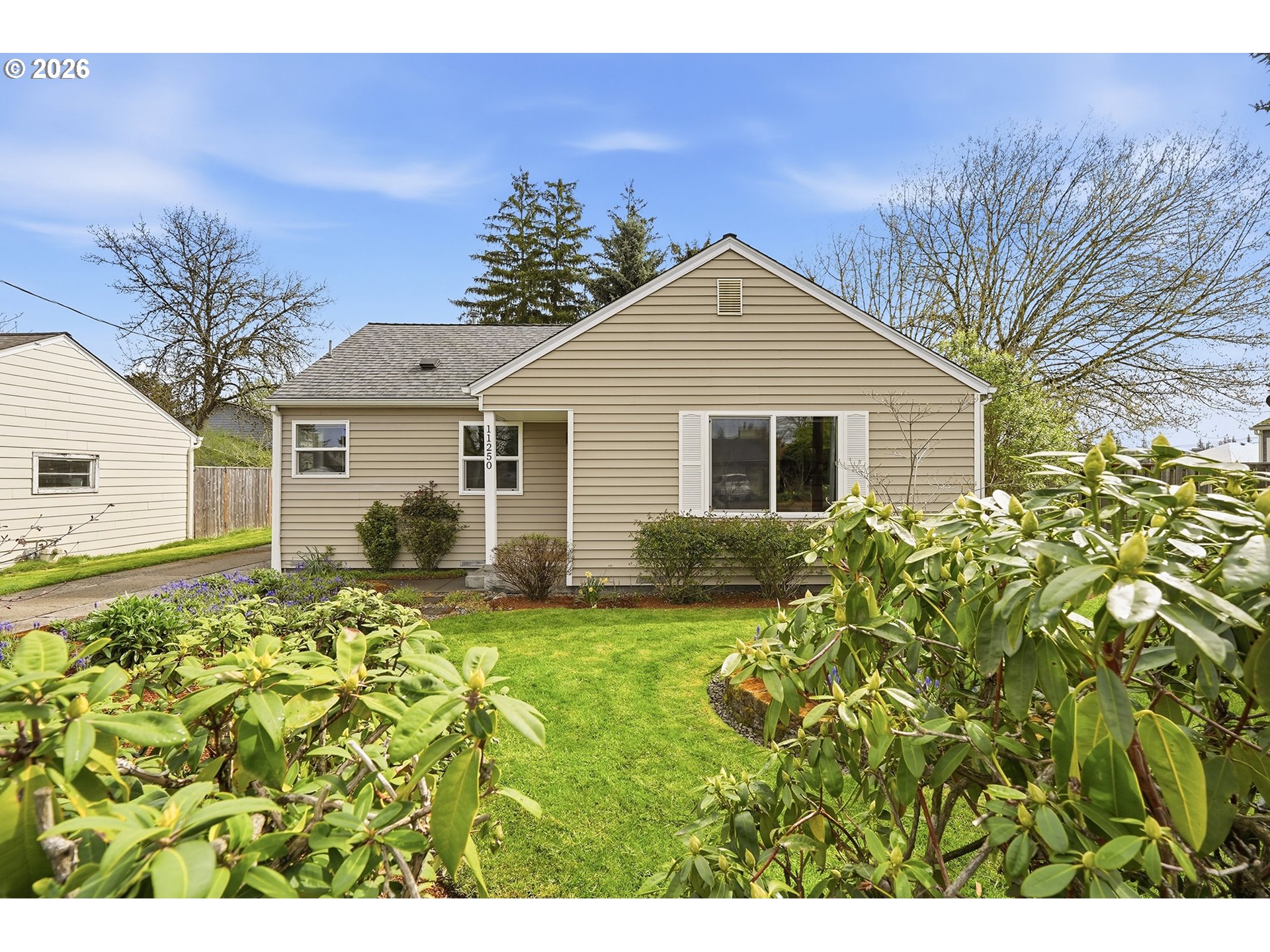 11250 Southwest 78th Avenue Tigard, OR 97223 - Photo 2 of 30 a view of a yard in front of a house with a large tree
