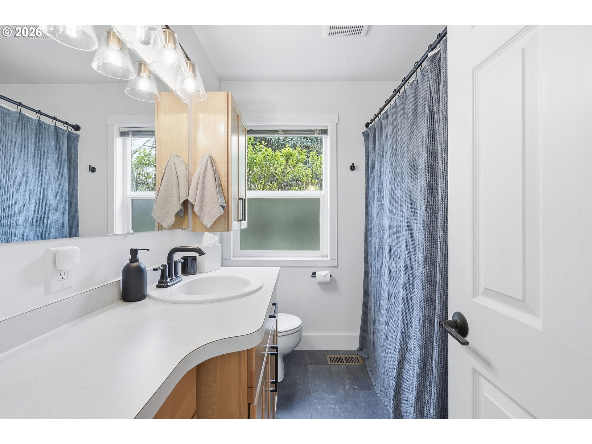 11250 Southwest 78th Avenue Tigard, OR 97223 - Photo 21 of 30 a bathroom with a sink a toilet and a mirror