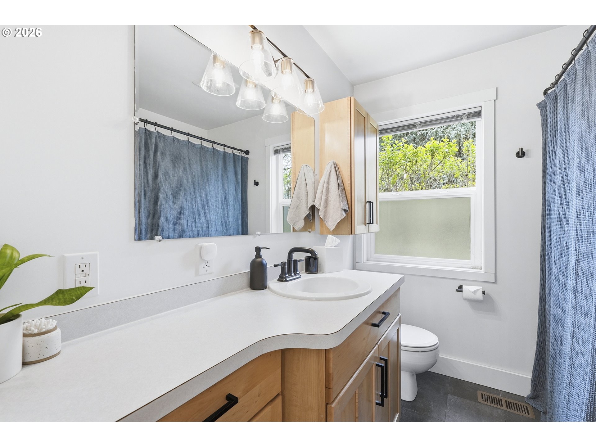 11250 Southwest 78th Avenue Tigard, OR 97223 - Photo 22 of 30 a bathroom with a sink toilet a mirror and bathtub