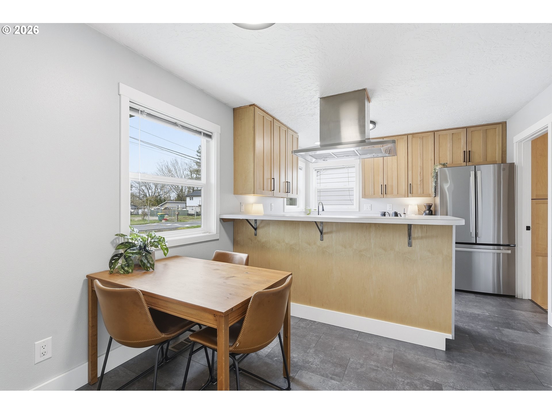 11250 Southwest 78th Avenue Tigard, OR 97223 - Photo 9 of 30 a kitchen with stainless steel appliances granite countertop a kitchen island hardwood floor sink and stove