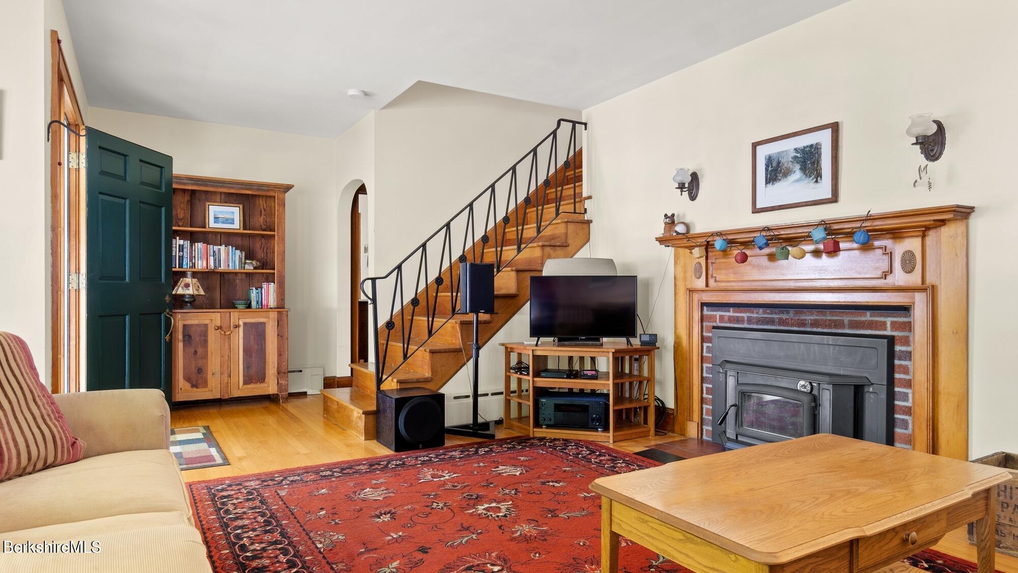 23 Ridgeway Avenue Pittsfield, MA 01201 - Photo 12 of 29 a living room with furniture a piano and a fireplace
